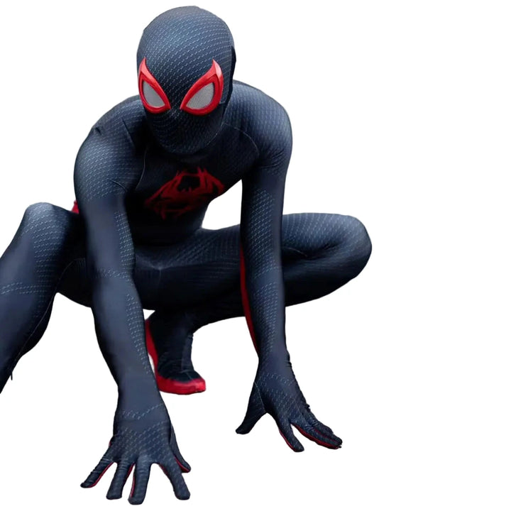 Person wearing a black superhero costume with red accents, crouching on a concrete surface.