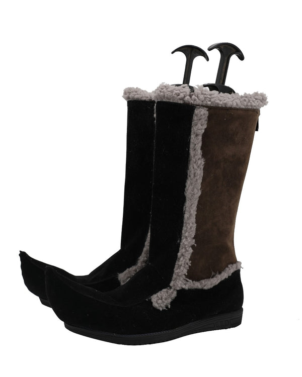 A pair of black, brown, and white Kristoff-style boots from the movie Frozen, with attached furry cuffs.
